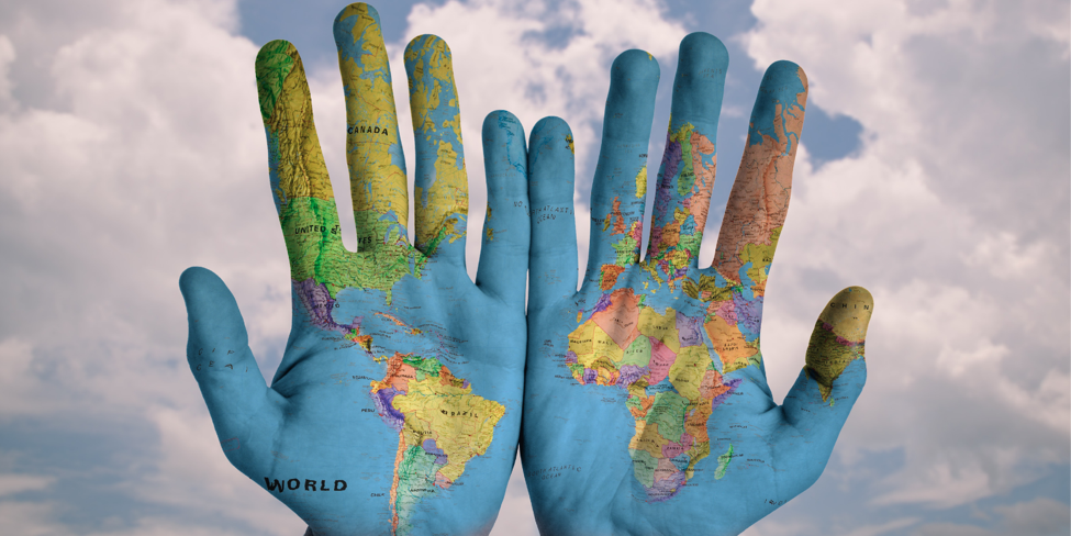 Hands painted with world map.