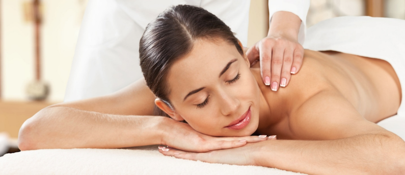 A relaxed-looking woman getting a Swedish massage. Learn different Massage Techniques at AMBI.
